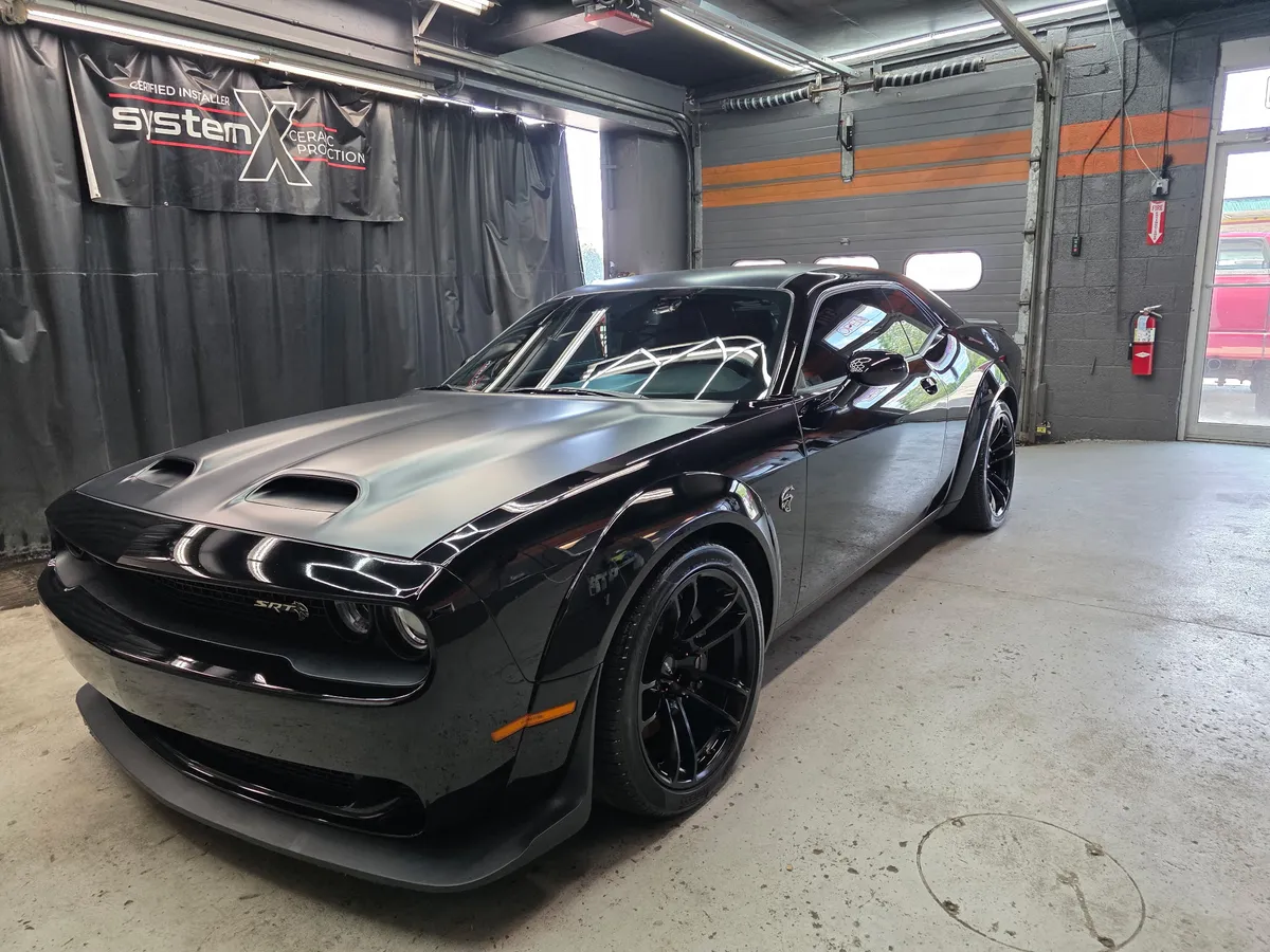 A widebody Dodge Challenger SRT in our paint-protection bay, where we're a certified System X ceramic coating installer.
